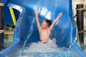 Boy Sliding Down Blue Tube